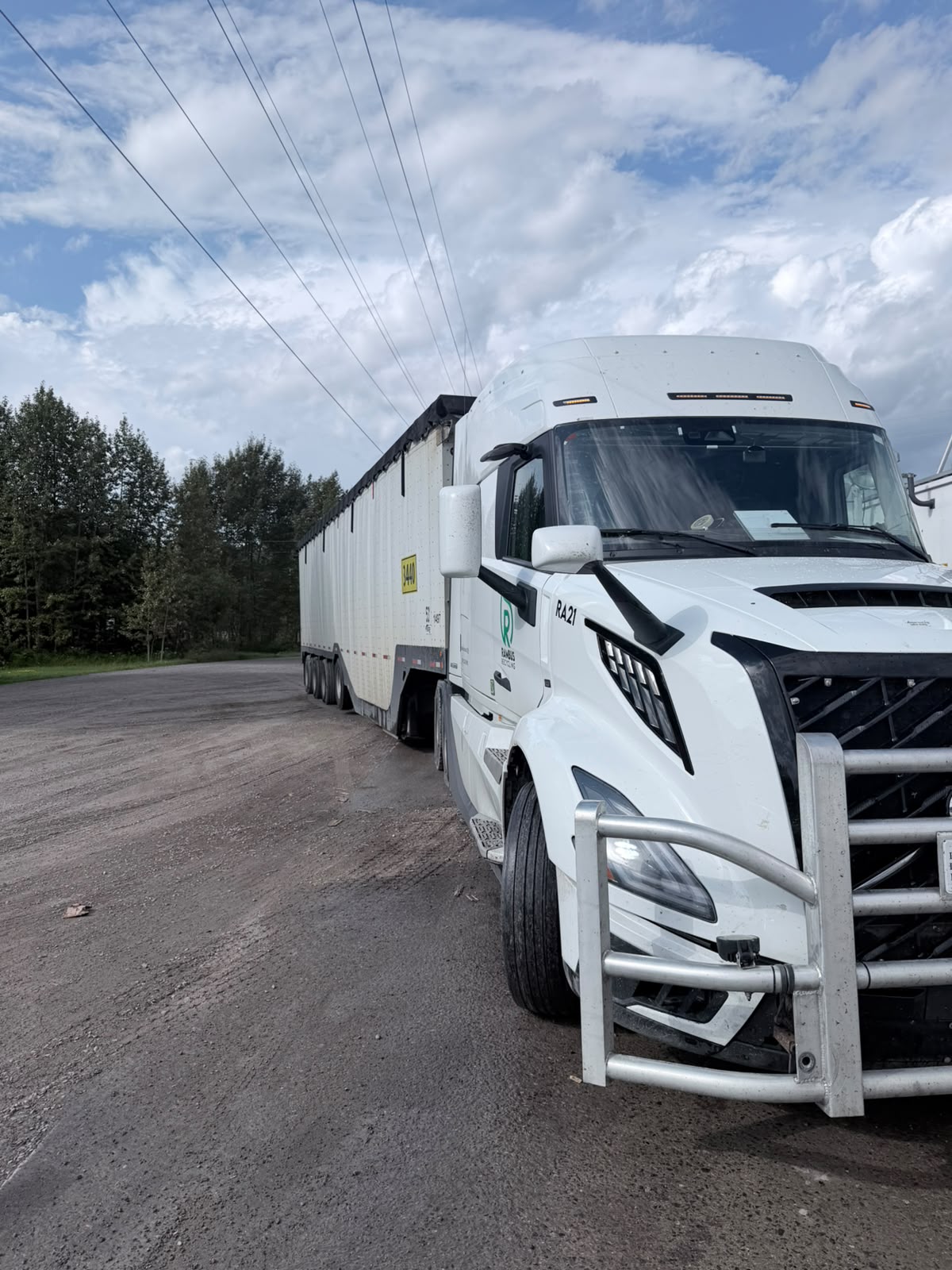 Loaded logging truck hauling timber along a rural highway
